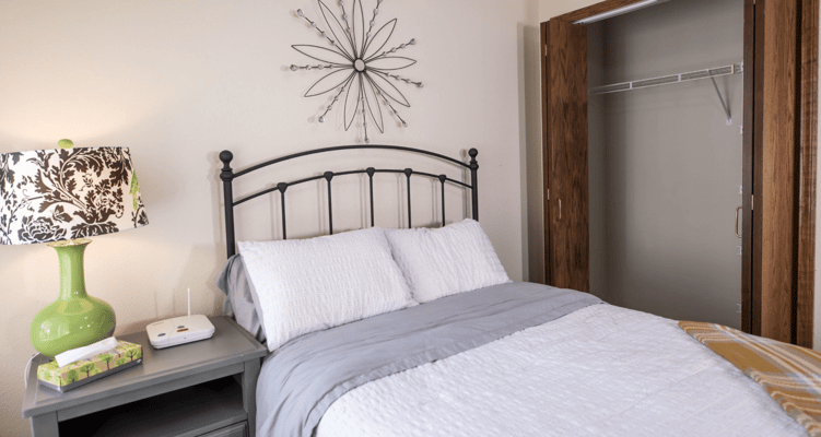 Cozy bedroom with a bed, lamp, and closet