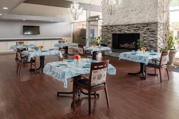 Dining area set up with tables and flowers