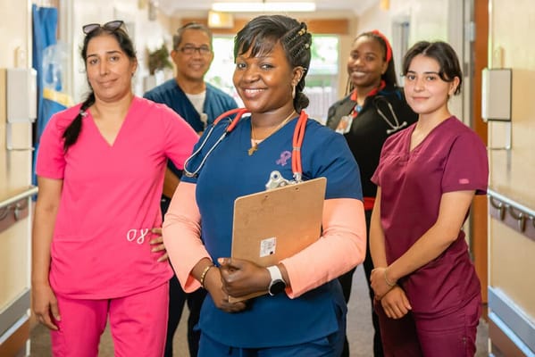 Healthcare staff posing together in a facility hallway