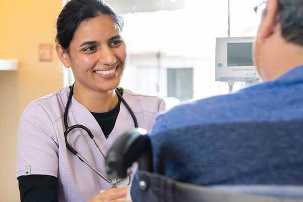 A nurse interacting with a patient in a care facility