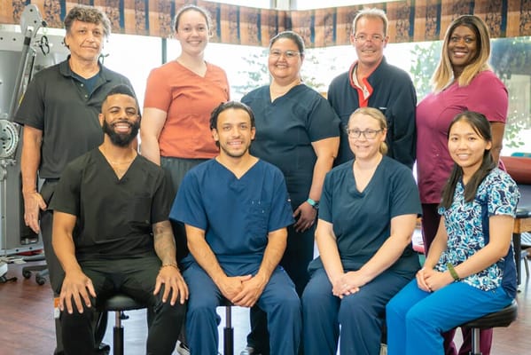 Staff members posing together in a facility