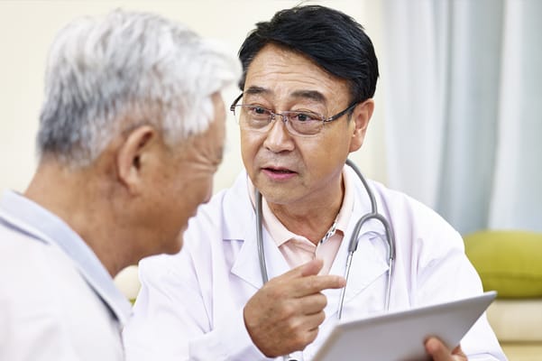 A doctor consulting with a senior resident indoors