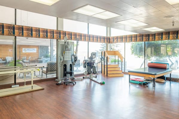 Interior view of a physical therapy gym with equipment