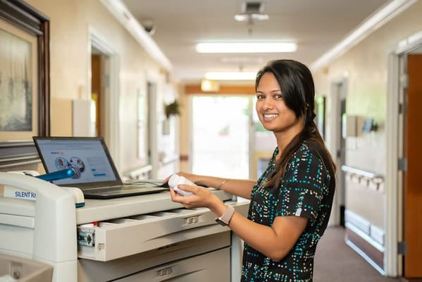 Staff member at a computer station in a hallway