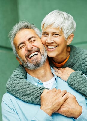 Happy older couple embracing outdoors
