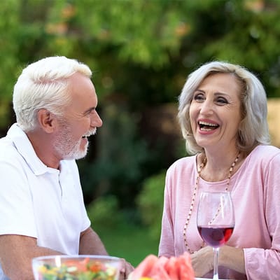 Seniors enjoying conversation in a garden setting
