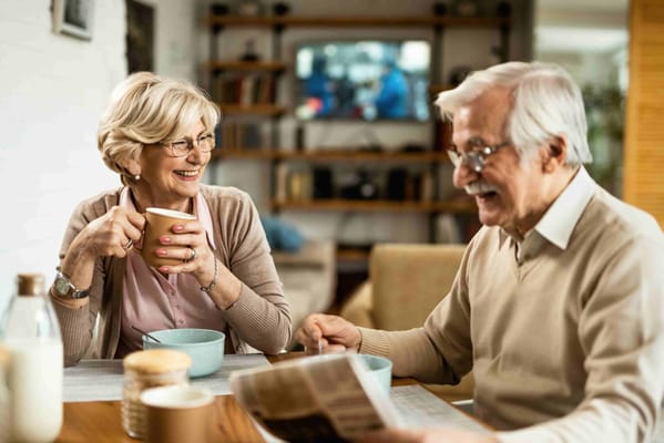 Couple enjoying coffee and reading in a cozy setting