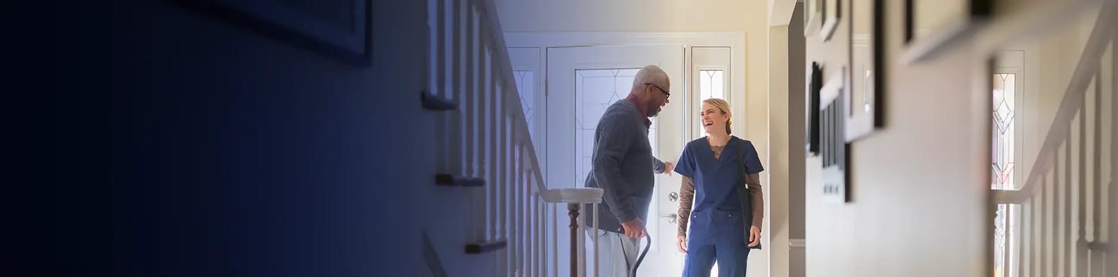 Nurse assisting a resident in a bright hallway