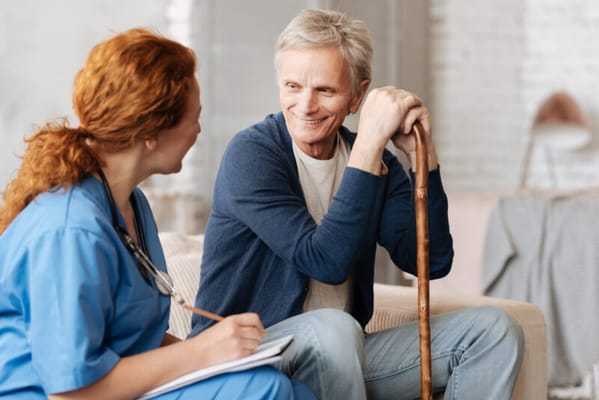 Nurse and resident engaging in conversation