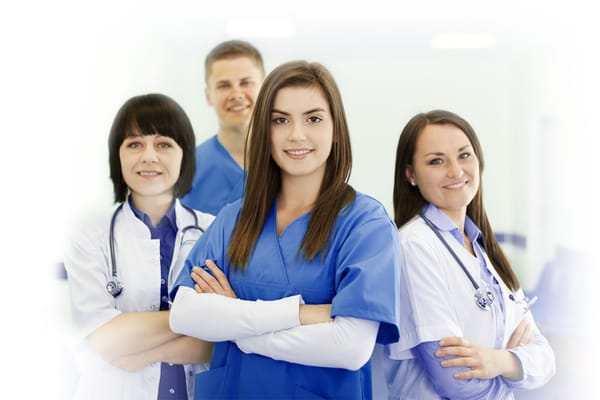 Healthcare professionals posed together in scrubs