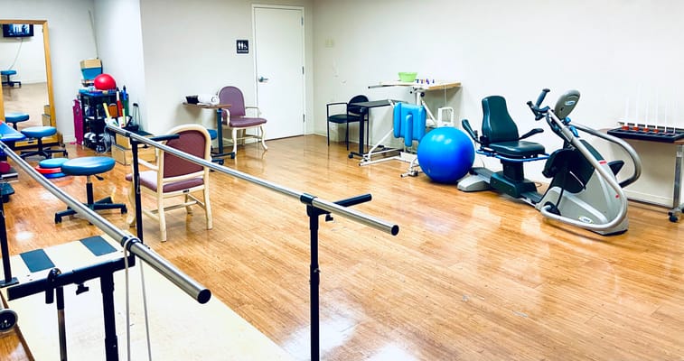 Physical therapy room equipped with exercise equipment