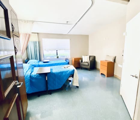 Bright interior of a resident room with two beds