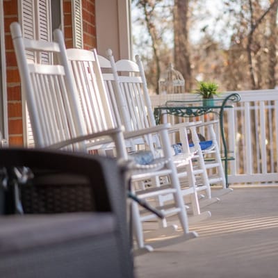 Rocking chairs on a porch in a serene setting
