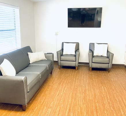 Bright common area with seating and television