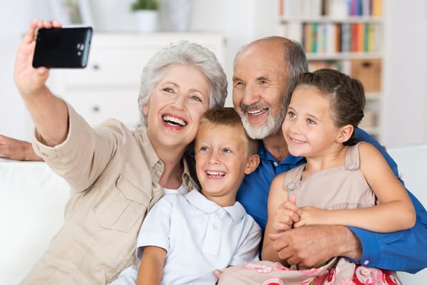 Family taking a selfie in a cozy indoor setting