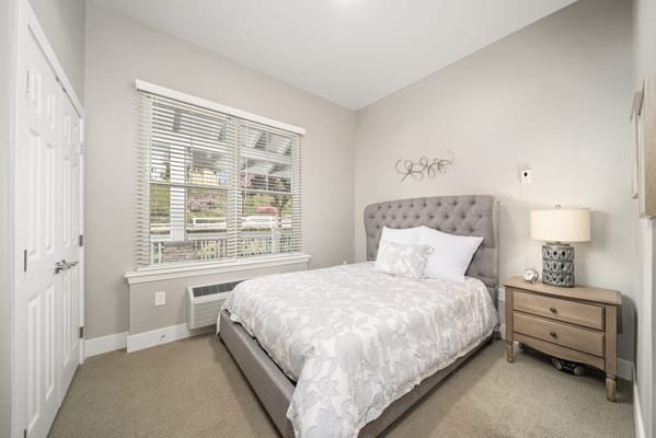 Cozy bedroom with a neatly made bed and natural light