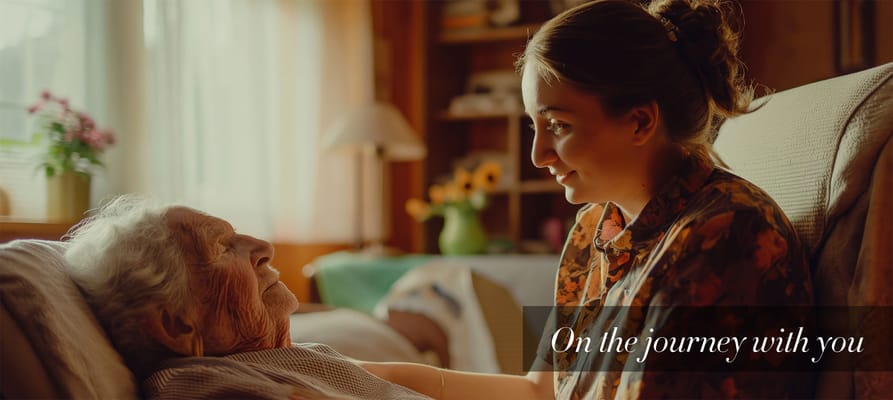 Staff member interacting with a resident in a cozy setting