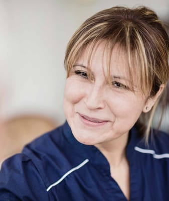 Close-up of a smiling staff member in a nursing facility