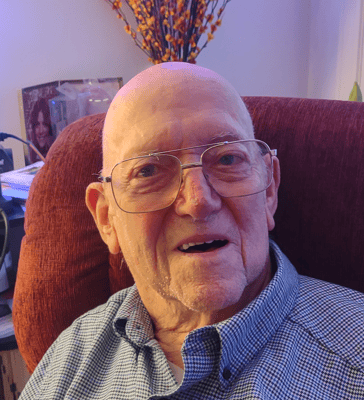 Smiling elderly man in a cozy chair