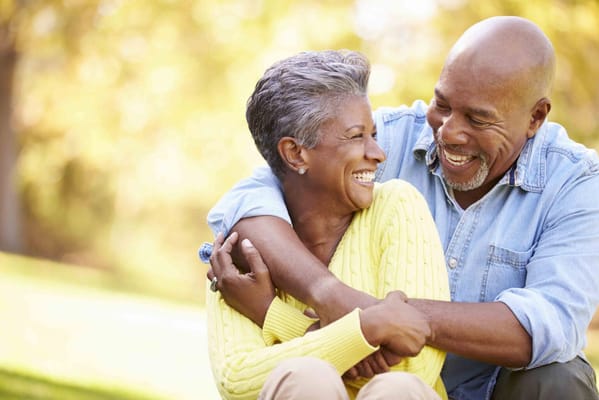 A couple smiling and enjoying time outdoors