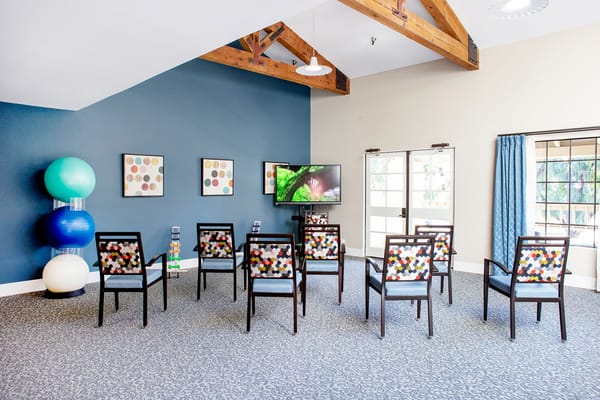 Interior activity room with seating and TV