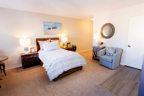 Cozy interior of a resident room with a bed and chair