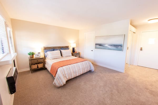 Well-decorated private resident room with bedding and artwork