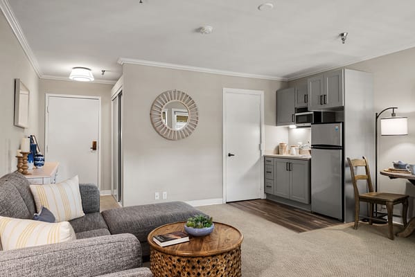 A cozy interior view of a resident unit with a kitchenette