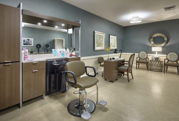 A well-lit salon area with styling chairs and decor