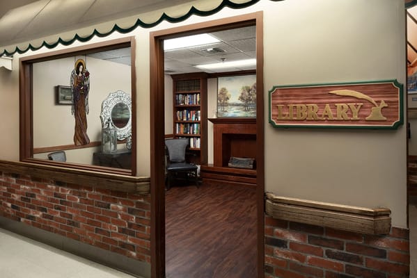Interior view of a library with wooden signage