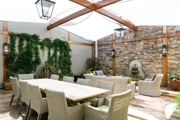 Outdoor patio area with seating and greenery