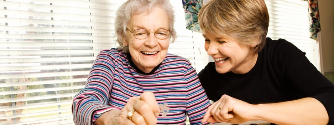 A resident engaging in an activity with a staff member