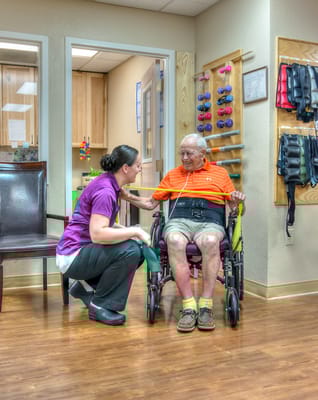 Staff assisting a resident in a therapy session