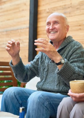 Senior man smiling while interacting with others