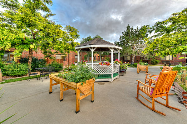 Outdoor gazebo with seating and garden beds