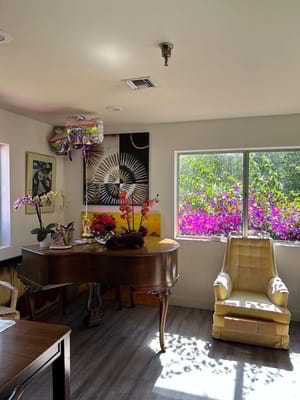 Brightly decorated common area with flowers and furniture