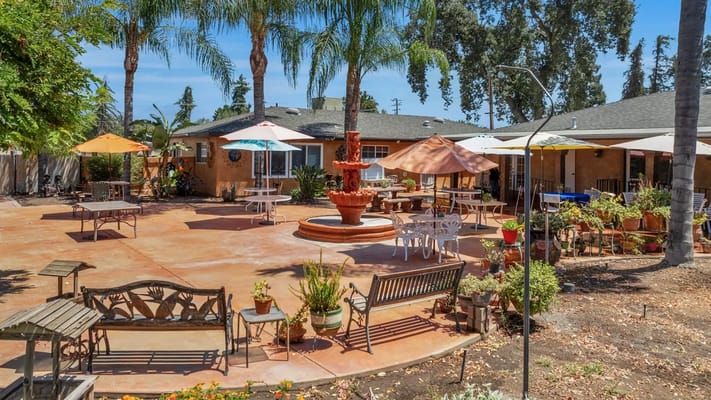 Outdoor patio area with seating and umbrellas
