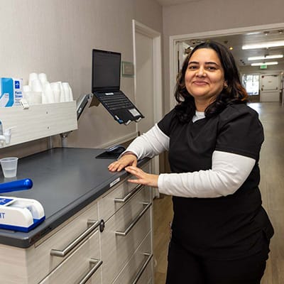Staff member smiling in a facility hallway