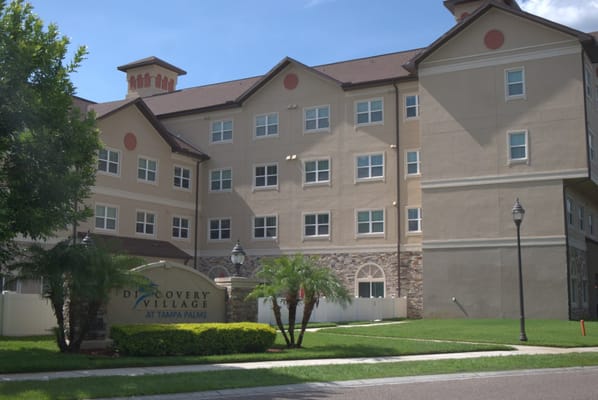 Facade of Discovery Village At Tampa Palms with landscaping
