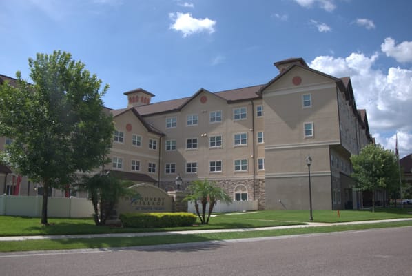 Exterior view of Discovery Village At Tampa Palms with green landscaping.