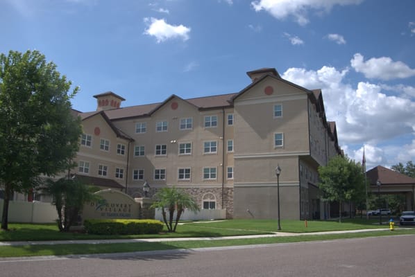 Exterior of Discovery Village at Tampa Palms, showcasing the building and landscaping.