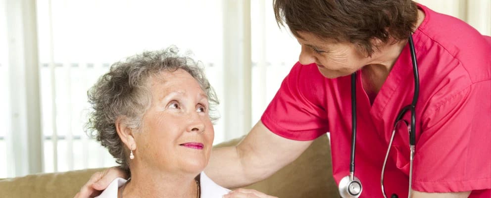 Nurse smiling at a resident in a comfortable setting