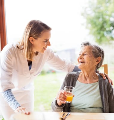 Staff member interacting with a resident at a table