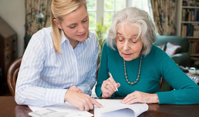 Staff assisting a resident with paperwork