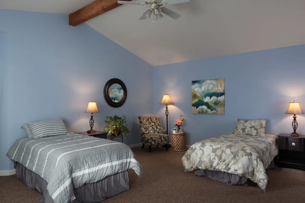 Brightly furnished resident room with two beds