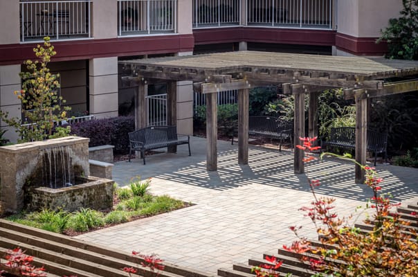 Outdoor shaded area with seating and water feature