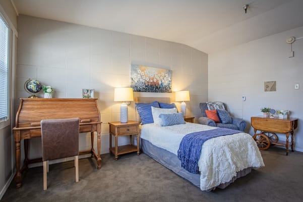 Cozy private resident room with a bed and desk