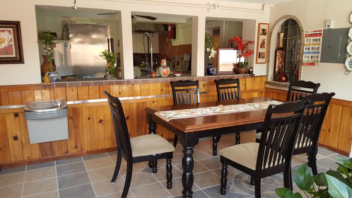 Brightly lit dining area with wooden furniture