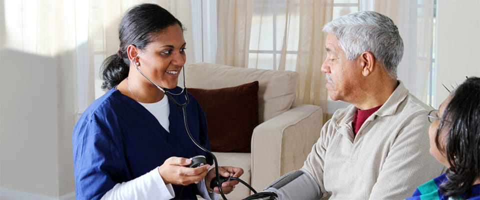Healthcare professional assisting a senior resident
