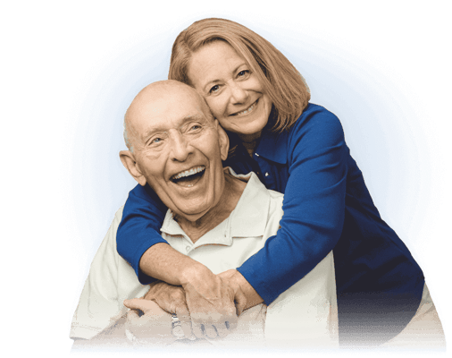 Happy elderly man with caregiver embracing